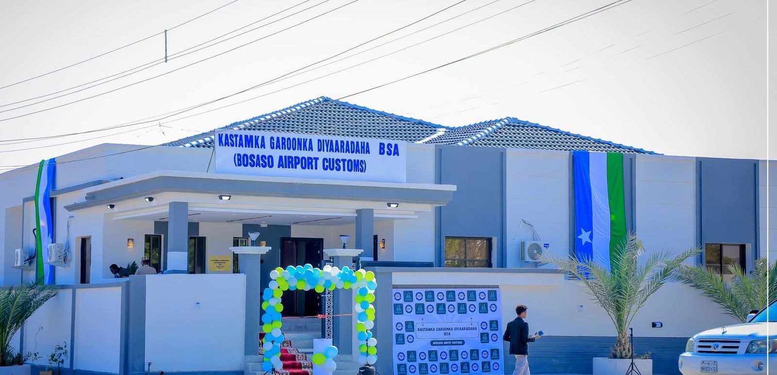 Opening-day branding, printed panels and entrance signage at Bosaso Airport Customs